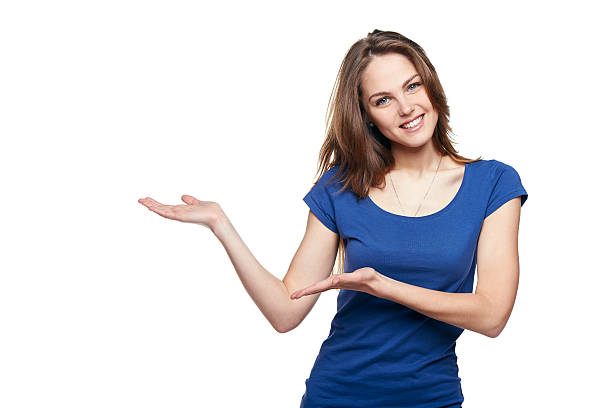 Smiling woman showing open hand palm with copy space for product or text